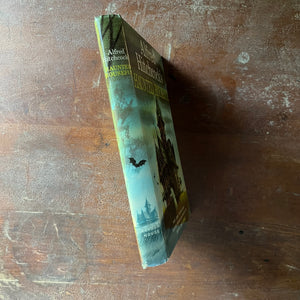 vintage mystery book for children - Alfred Hitchcock's Haunted Houseful written by Alfred Hitchcock with illustrations by Fred Banbery - view of the spine with the front cover illustration wrapping around the spine - there is a bat on the spine