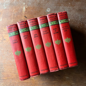 antique book set in red and green - Classic American Literature Book Set Written by Louisa May Alcott - Little Women, Little Men, Jo's Boys, Eight Cousins, Rose in Bloom and An Old-Fashioned Girl - cover art by Anna Bond - view of the decorative spines 