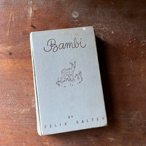 vintage children's chapter book, classic literature - Bambi written By Felix Salten with illustrations by Kurt Weise 1931 Edition - view of the embossed front cover with title & author listed as well as a small illustration of Bambi in the middle all on a gray background