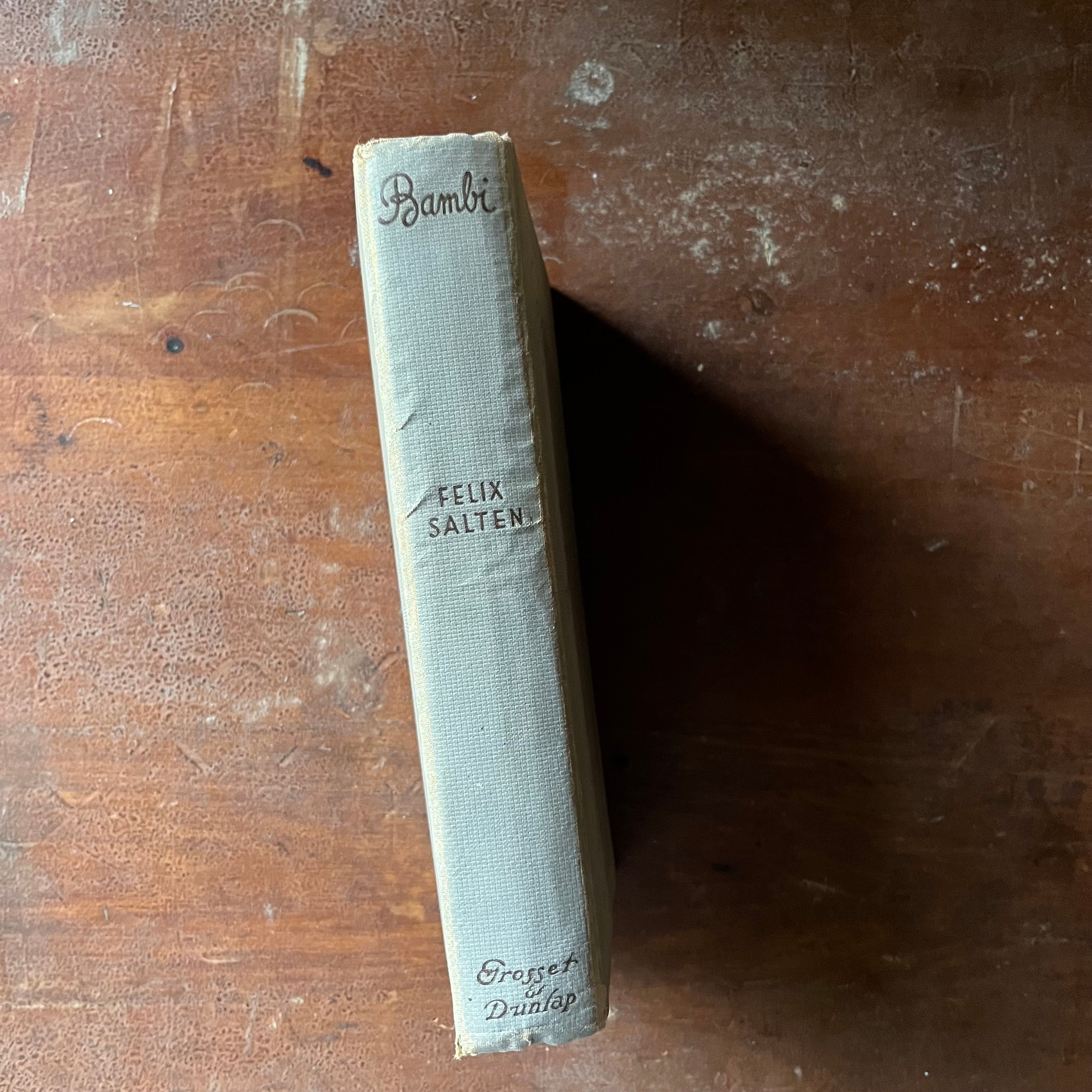 vintage children's chapter book, classic literature - Bambi written By Felix Salten with illustrations by Kurt Weise 1931 Edition - view of the spine - gray with title, author & publisher listed