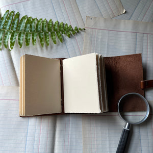 Blank Leather Travel Journals - handmade leather journal - view of the cream colored, hand-torn paper inside the lighter cover journal