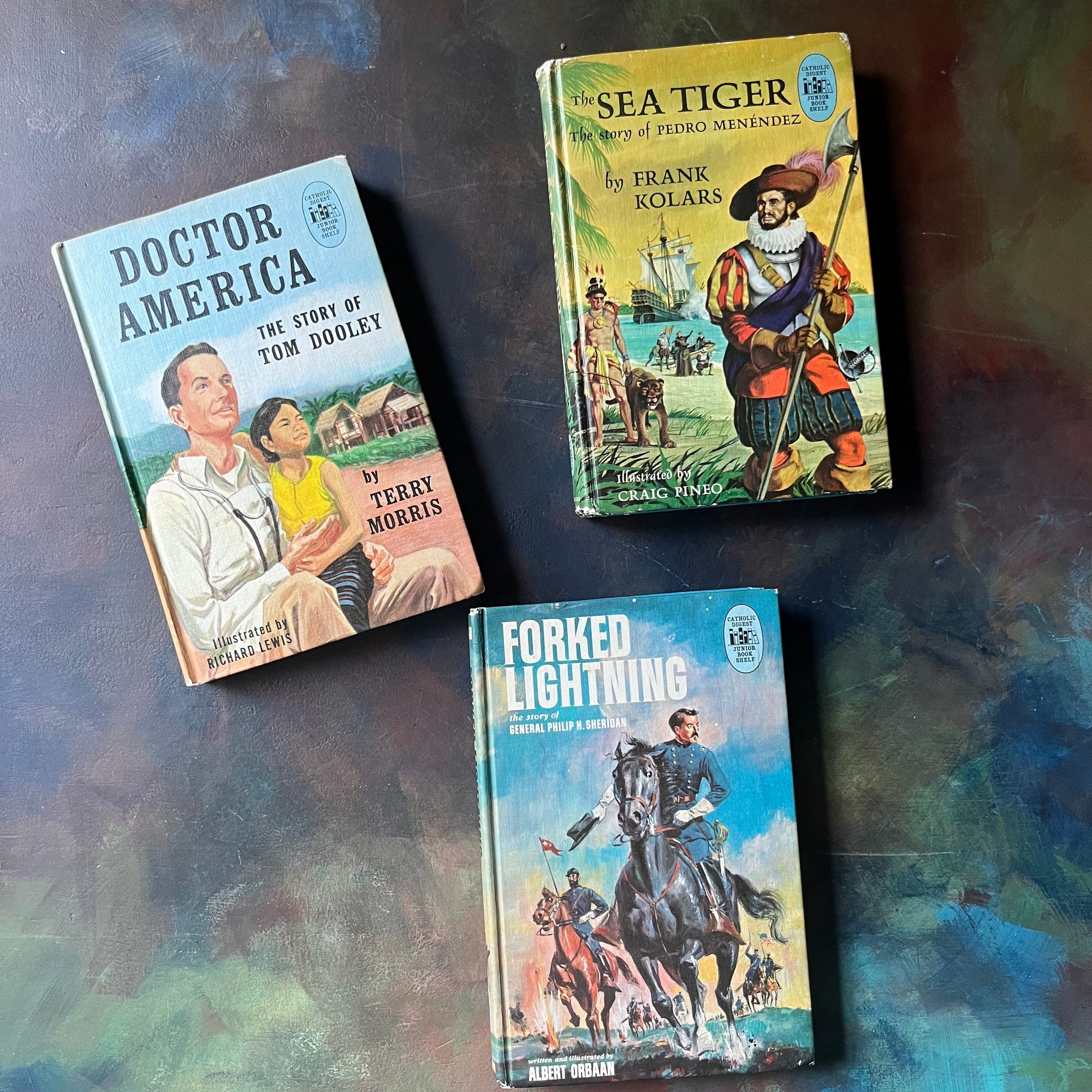 Set of Three Catholic Digest Junior Book Shelf Books-Forked Lightning The Story of General Philip H. Sheridan, The Sea Tiger The Story of Pedro Menendez, and Doctor America The Story of Tom Dooley-view of the front covers