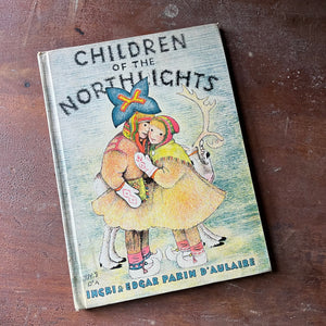 vintage children's picture book, vintage book, children's book - Children of the Northlights written & illustrated by Ingri & Edgar Parin D'Aulaire - view of the front cover featuring two children with a reindeer