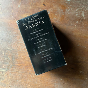 vintage children’s books, children’s books, chapter books, Scholastic box set – The Chronicles of Narnia Complete Box Set written by C. S. Lewis with Illustrations by Pauline Baynes - view of the back of the box sleeve listing the books in chronological order