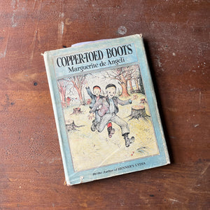 Copper-Toed Boots written & Illustrated by Marguerite de Angeli-1938 Edition with Dust Jacket-Autographed Edition-vintage picture book-view of the dust jacket's front cover with an illustration of two children running in a wooded lot