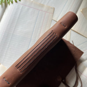 Handmade Leather Journal - guest book, blank journal, nature journal, book journal, gratitude journal - view of the front cover with a stamped fern on suede hand-stitched to the leather cover. Long-stitch binding on spine