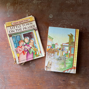 vintage children's chapter book-Newbery Honor Book - Little Town on the Prairie with dust jacket written by Laura Ingalls Wilder with illustrations by Garth Williams - view of the back cover depicting a prairie town scene