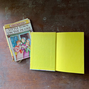 vintage children's chapter book-Newbery Honor Book - Little Town on the Prairie with dust jacket written by Laura Ingalls Wilder with illustrations by Garth Williams - view of the inside cover in bright yellow