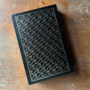 vintage children's chapter book, classic literature, gift book by Easton Press - Moby Dick or The Whale written by Herman Melville with illustrations by Broadhead Robinson - view of the embossed back cover - all waves framed in a rectangle