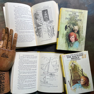 Set of Four Nancy Drew Mysteries written by Carolyn Keene-Books Twelve - Fifteen:  The Mystery in the Hollow Oak, The Mystery of the Ivory Charm, The Whispering Statue, and the Haunted Bridge-view of the illustrations