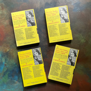 Set of Four Nancy Drew Mysteries written by Carolyn Keene-Books Twelve - Fifteen:  The Mystery in the Hollow Oak, The Mystery of the Ivory Charm, The Whispering Statue, and the Haunted Bridge-view of the back covers
