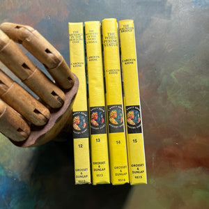 Set of Four Nancy Drew Mysteries written by Carolyn Keene-Books Twelve - Fifteen:  The Mystery in the Hollow Oak, The Mystery of the Ivory Charm, The Whispering Statue, and the Haunted Bridge-view of the spines