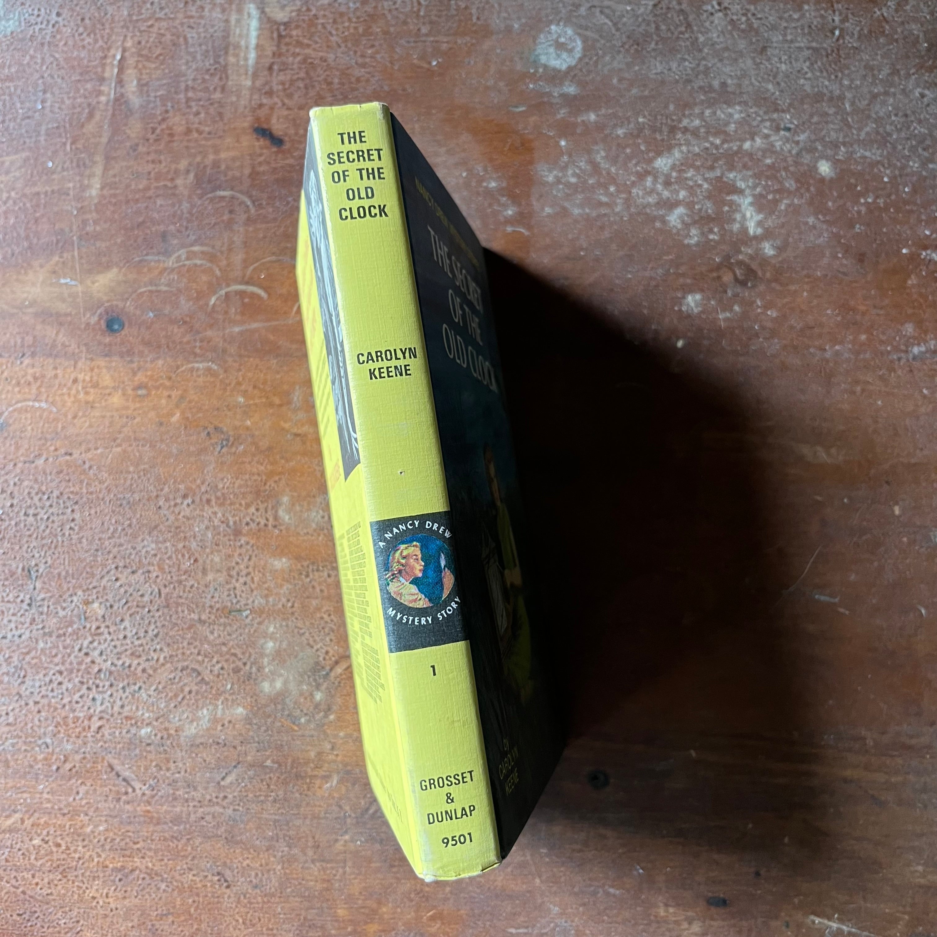 vintage children's chapter books, adventure books for girls - Nancy Drew Mystery Stories #1 The Secret of the Old Clock written by Carolyn Keene with illustrations by Rudy Nappi - view of the spine