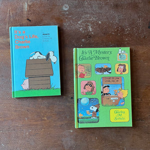  vintage children's picture books/cartoon books - Pair of vintage children's cartoon books written & illustrated by Charles M. Schulz Books for Children:  It's a Dog's Life, Charlie Brown & It's a Mystery, Charlie Brown - view of the front covers