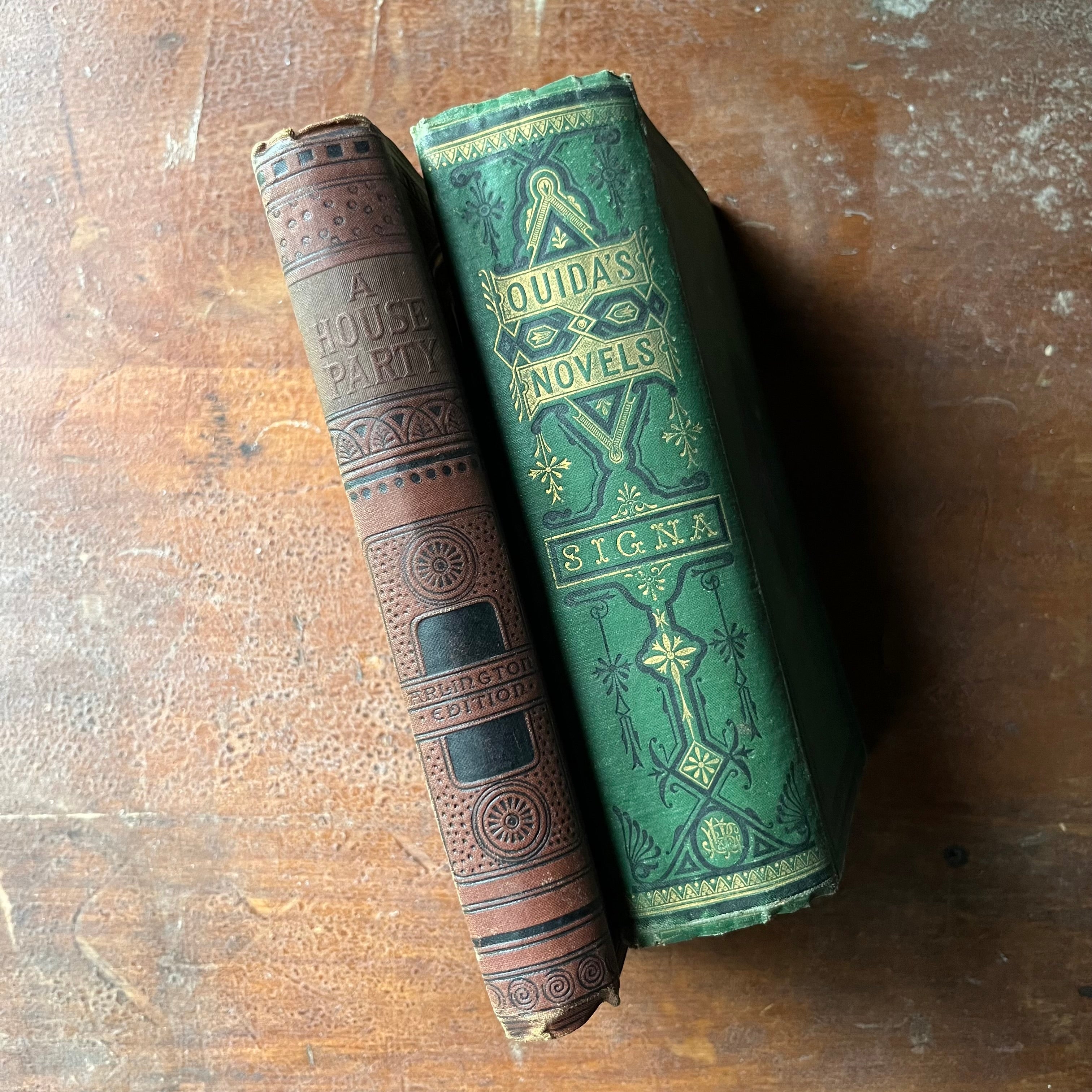 antique books, antique fiction books - Pair of books written by Ouida-A House Party (an Arlington Edition) & Signa - view of the embossed spines