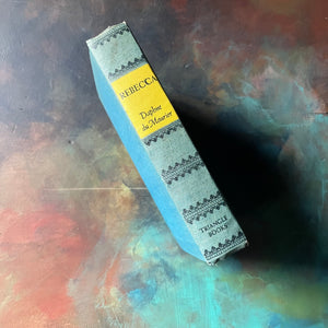 Rebecca by Daphne du Maurier-Triangle Books Edition-classic literature-Alfred Hitchcock-vintage mystery novel-view of the spine with a pop of yellow where the title & author are listed