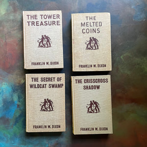Set of Four Hardy Boys Books written by Franklin W. Dixon-Brown Tweed Covers-The Tower Treasure, The Melted Coins, The Secret of Wildcat Swamp & The Crisscross Shadow-view of the front covers