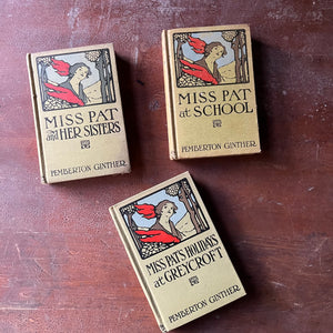 vintage children's chapter books - Set of Three Miss Pat Books written & possibly illustrated by Pemberton Ginther-At School-And Her Sisters-Holidays at Greycroft - view of the embossed front covers with an illustration of Miss Pat