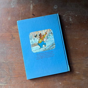 vintage children's picture book, 1980's Children's Literature - The Berenstain Bears' Christmas Tree written & illustrated by Stan and Jan Berenstain - view of the glossy back cover with an illustration of Pa Bear holding an ax & pointing up a hill