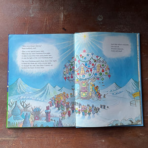 vintage children's picture book, 1980's Children's Literature - The Berenstain Bears' Christmas Tree written & illustrated by Stan and Jan Berenstain - view of the berenstain bears treehouse where they live all decorated for Christmas with the town all gathered round the tree