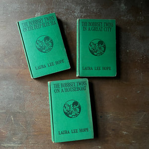 antique children's books , vintage children's chapter books, collectible books - The Bobbsey Twins Book Set-On The Deep Blue Sea, In a Great City and On a Houseboat written by Laura Lee Hope - view of the embossed front covers