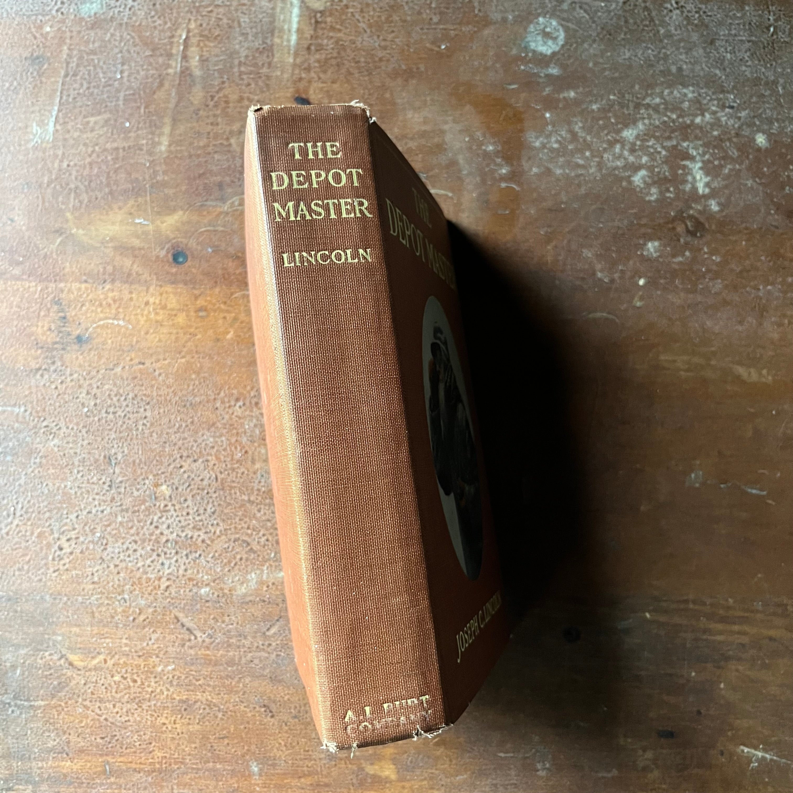 antiquarian book, novel - The Depot Master written by Joseph C. Lincoln with illustrations by Howard Heath - view of the spine with the title & author's last name at the top