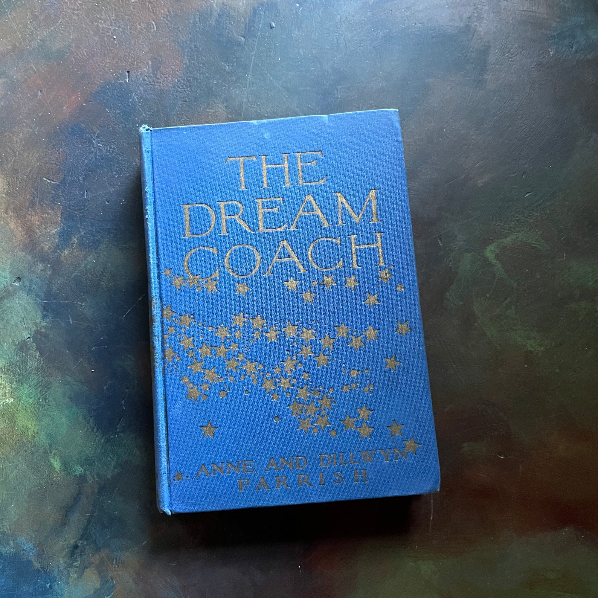 The Dream Coach written by Anne and Dillwyn Parrish-vintage children's short stories book-view of the embossed front cover with a blue background & gold stars & title