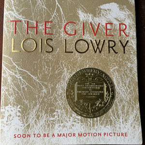 The Giver Quartet Book Set written by Lois Lowry-The Giver, Gathering Blue, Messenger, and Son-Newbery Award Winning Book-Dystopian Young Adult Science Fiction-view of the Newbery Medal Gold Seal on the front of The Giver