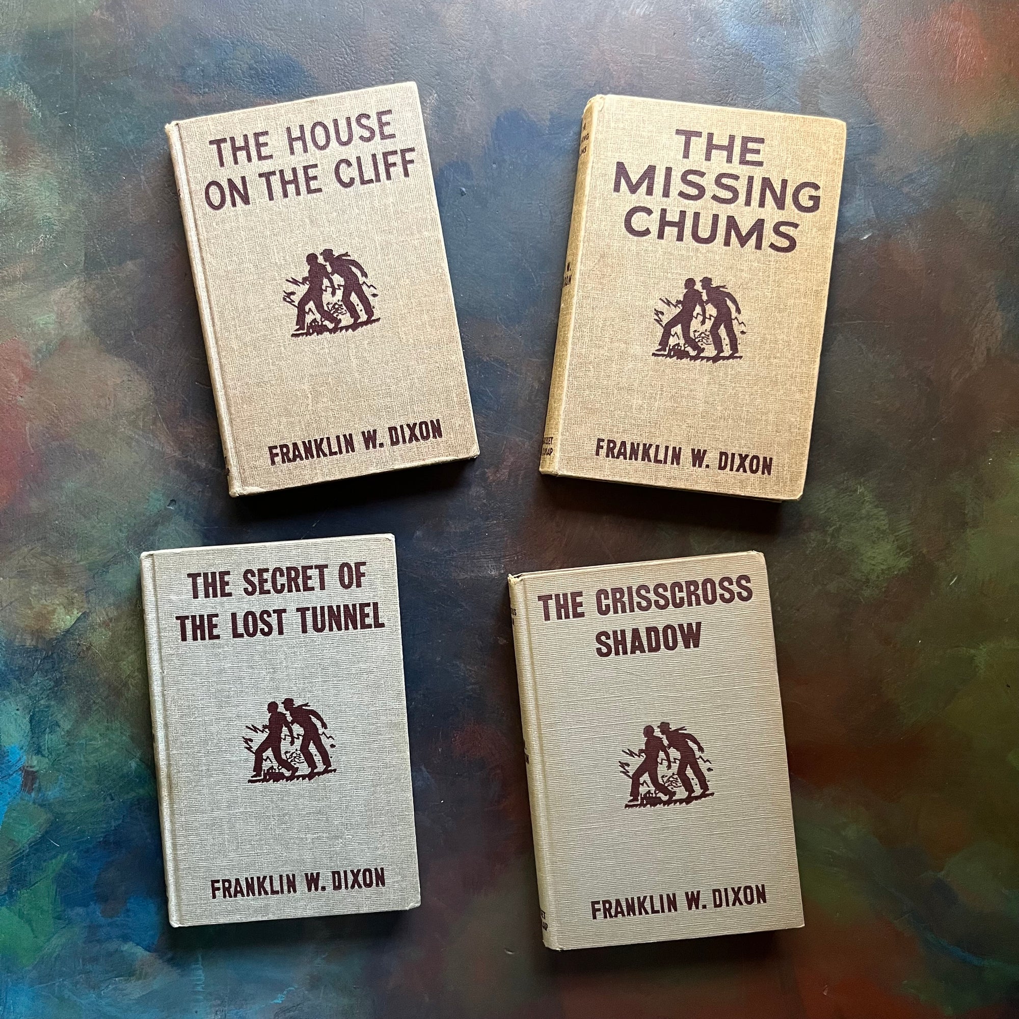 The Hardy Boys Mysteries by Franklin W. Dixon-The House on the Cliff-The Missing Chums-The Crisscross Shadow-The Secret of the Lost Tunnel-children's chapter books-view of the front covers in the older brown tweed design