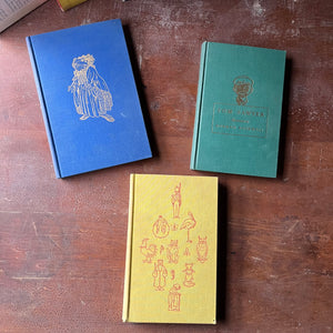 The Heritage Illustrated Bookshelf-Set of Three Books-Andersen's Fairy Tales, The Wind in the Willows & Tom Sawyer-view of the embossed front covers in blue, green& yellow - all include an illustration of characters within the pages