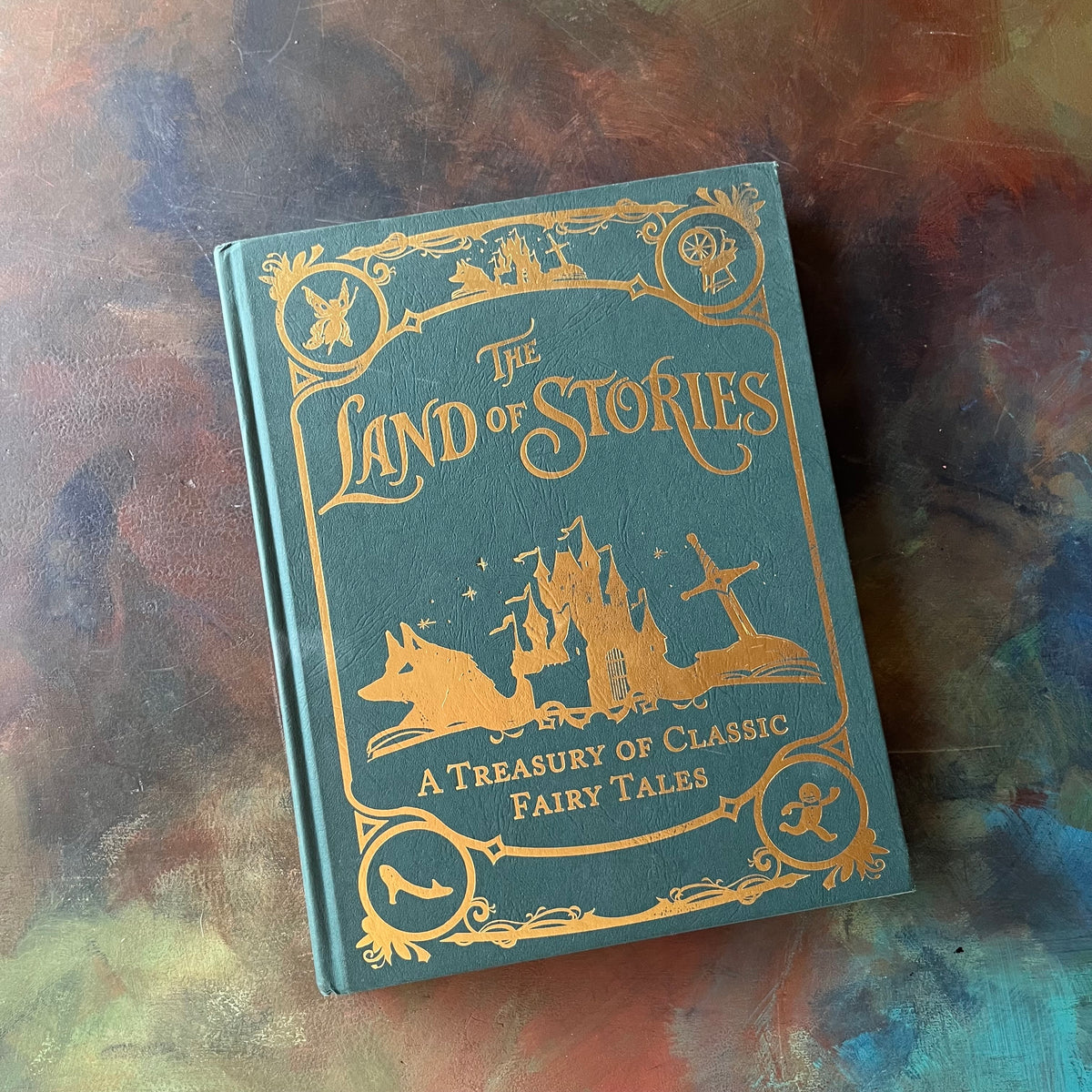 The Land of Stories-A Treasury of Classic Fairy Tales-Chris Colfer-Brothers Grimm-Hans Christian Andersen-fairy tales for children-Mother Goose Nursery Rhymes-view of the embossed front cover in green & gold 