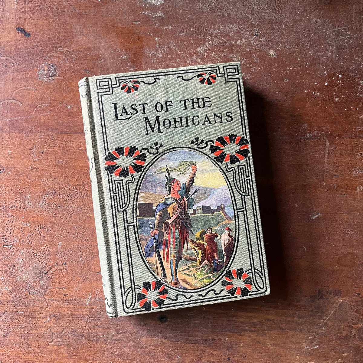 antiquarian book, vintage chapter book, classic American literature - The Last of the Mohicans written by James Fenimore Cooper - view of the embossed front cover