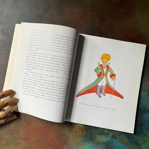 Antoine De Saint-Exupery's The Little Prince-classic children's literature-view of the full page. color illustration of the little prince with robe & sword