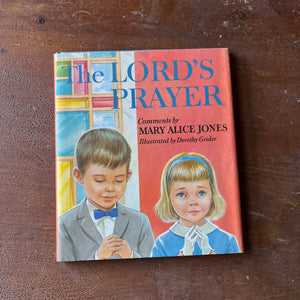 Log Cabin Vintage - vintage children's book, vintage religious book, Learning the Lord's Prayer - The Lord's Prayer Comments by Mary Alice Jones with Illustrations by Dorothy Grider - view of the dust jacket's front cover with two children with their hands folded as though they were praying