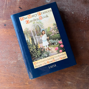 The Mary Frances Garden Book:  Adventures Among The Garden People written by Jane Eayre Fryer-Lacis Edition - view of the dust jacket's front cover with an illustration of a girl tending a garden