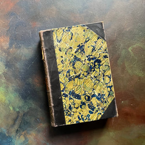 The Pioneers written by James Fenimore Cooper-book one of the leather stocking tales-antique leather-bound book with marbled cover-vintage adventure book-view of the marbled cover
