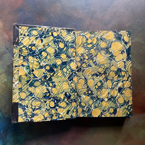 The Pioneers written by James Fenimore Cooper-book one of the leather stocking tales-antique leather-bound book with marbled cover-vintage adventure book-view of the marbled inside cover which matches the outside covers marbling