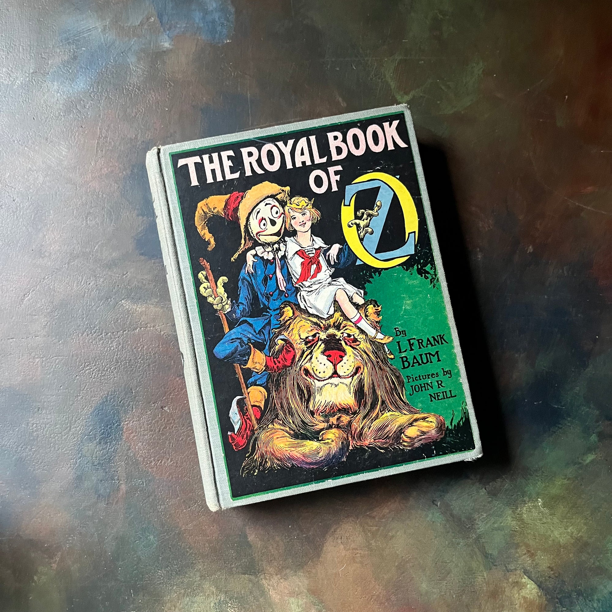 The Royal Book of Oz-L. Frank Baum-Wizard of Oz Book Series-vintage children's chapter book-vintage children's fiction-view of the front cover with an illustration of the scarecrow & the lion