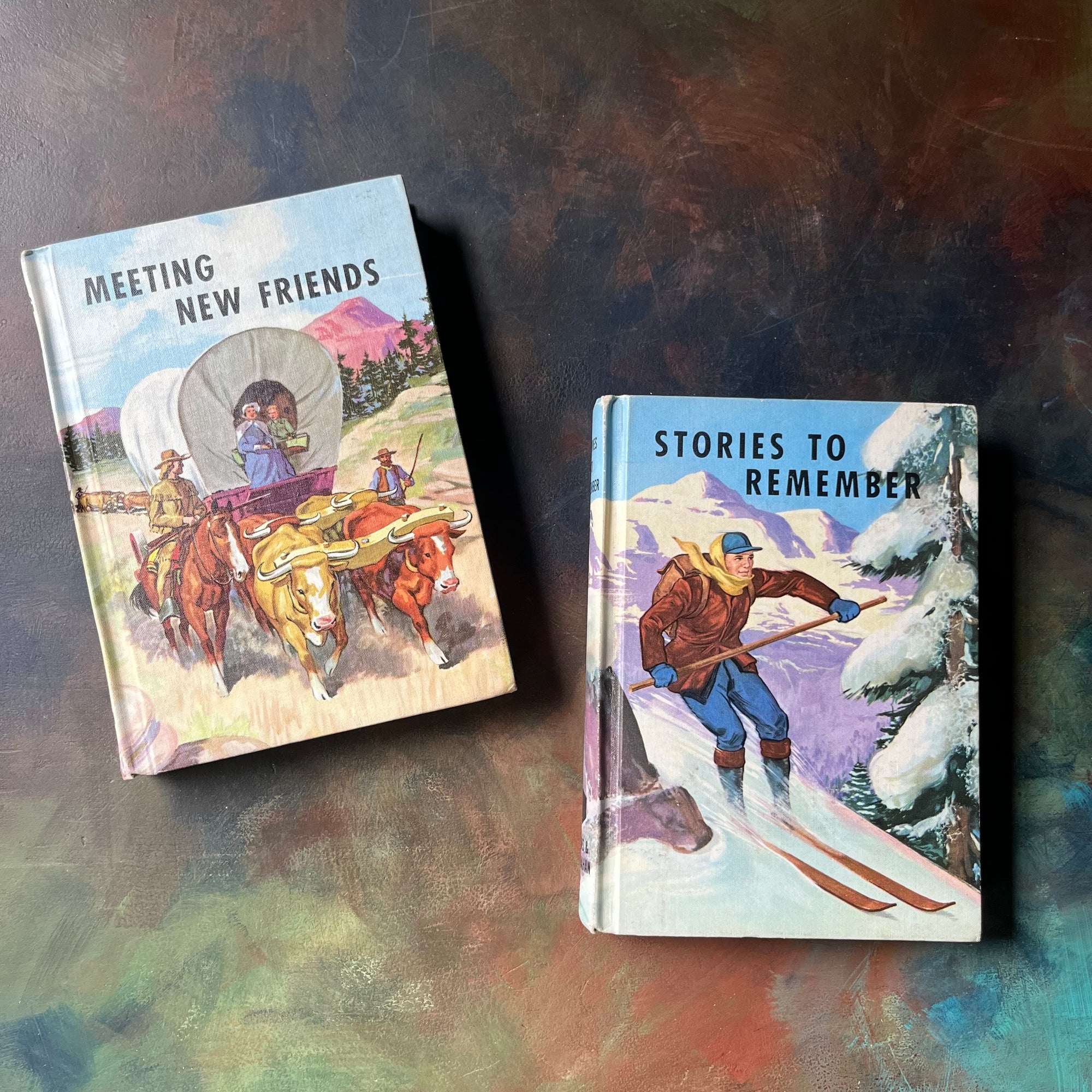 The Developmental Reading Series Book Set  Stories to Remember & Meeting New Friends-view of the front covers with a man skiing on one & a family in a covered wagon on the other