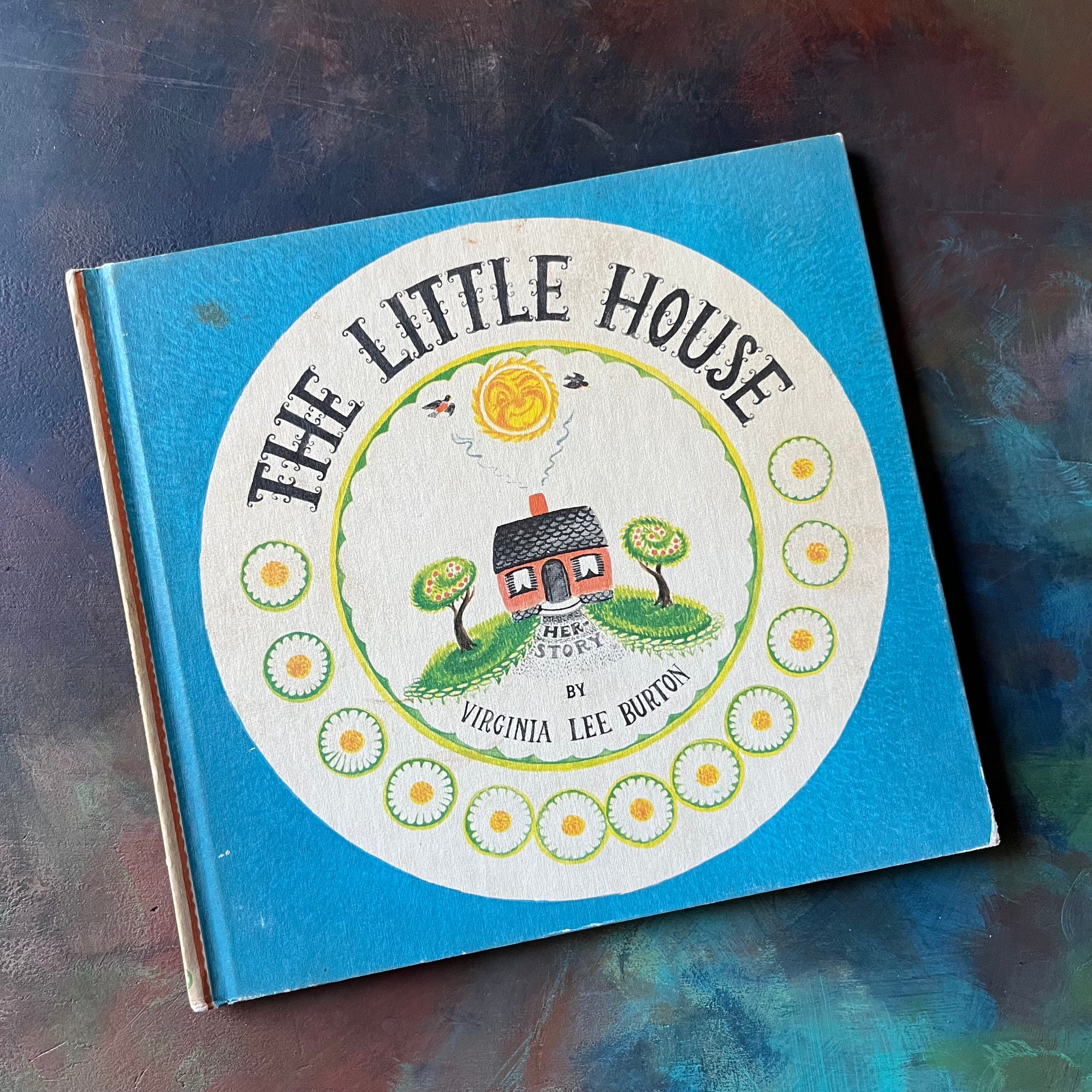 The Little House written & illustrated by Virginia Lee Burton-vintage children's picture book, Caldecott Award Winning Book - view of the front cover with an illustration of the little house below a smiling sun