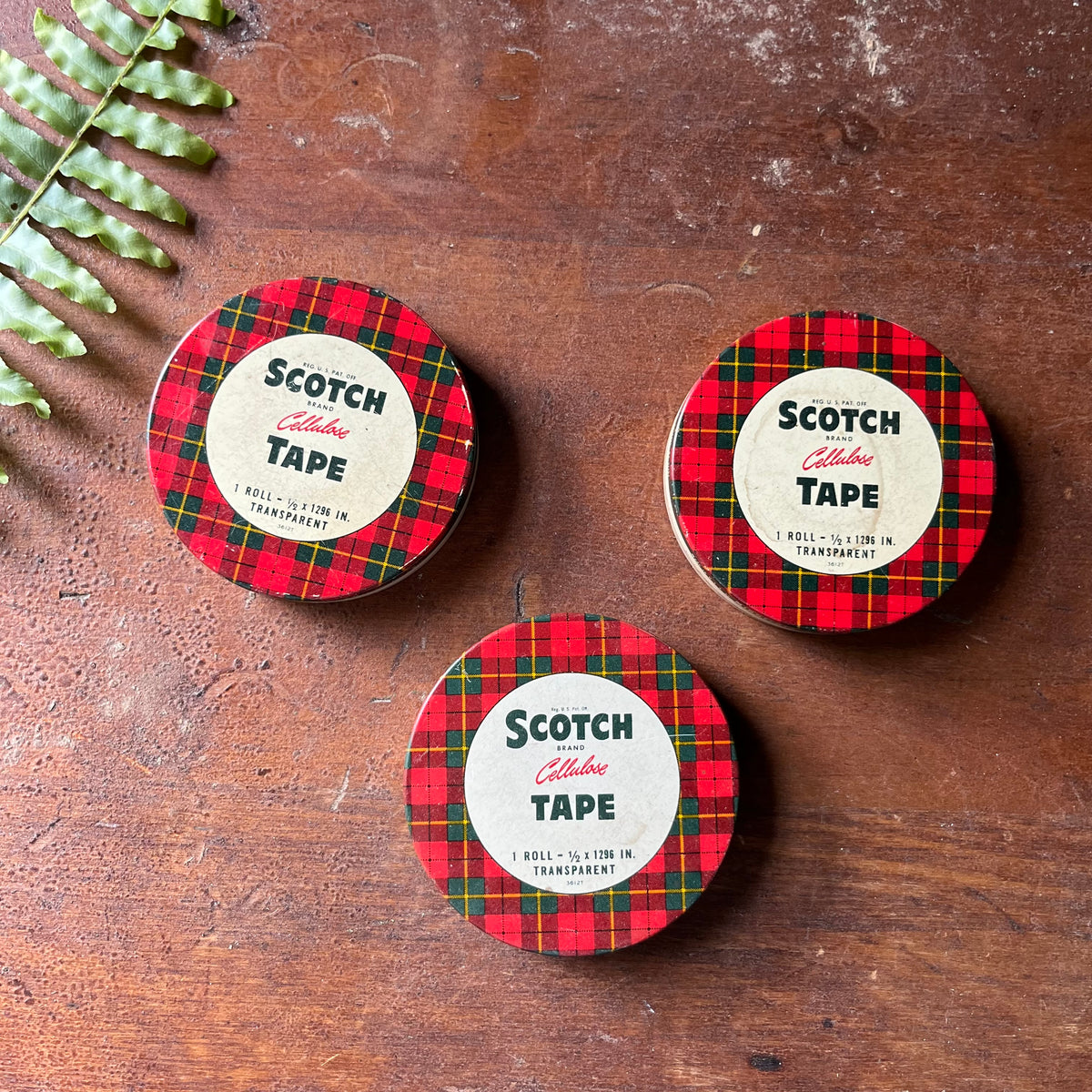 Trio of Small Scotch Plaid Cellulose Tins - view of the tops of the tins with their iconic plaid pattern around the edges