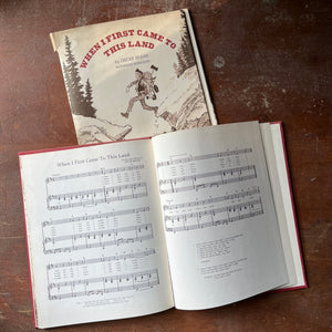 vintage children's picture book, folk song - When I First Came to this Land written by Oscar Brand with illustrations by Doris Burn - view of the sheet music for the song included at the back of the book