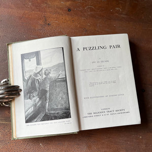 A Puzzling Pair by Amy Le Feuvre - view of the title page with full page illustration of children looking out of a train window
