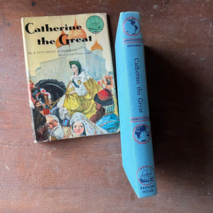 Log Cabin Vintage – vintage children’s book, children’s book, chapter book, living history book, history book, non-fiction, Landmark Series Book – Catherine the Great by Katharine Scherman with illustrations by Pranas Lape - view of the embossed spine showing the landmark series emblem, book title  & maps of the world