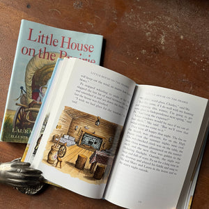 Log Cabin Vintage – vintage children’s book, children’s book, chapter book, living history - Little House on the Prairie 75th Anniversary Edition by Laura Ingalls Wilder with Illustrations by Garth Williams – view of the full color illustrations by Garth Williams - inside view of the log cabin