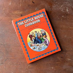Log Cabin Vintage – vintage children’s book, children’s book, chapter book, living history book, history book, non-fiction - The Little House Cookbook by Barbara M. Walker with Illustrations by Garth Williams - view of the book sitting on an old wood table top showing the front cover