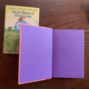 On the Banks of Plum Creek by Laura Ingalls Wilder - a 1981 HarperCollins Publisher Edition with Dust Jacket