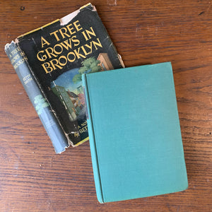 Log Cabin Vintage - vintage fiction, American Author, American novel - A Tree Grows in Brooklyn by Betty Smith - view of the book on a wood table showing the front cover on top of the dust jacket