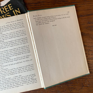 Log Cabin Vintage - vintage fiction, American Author, American novel - A Tree Grows in Brooklyn by Betty Smith - view of the book on a wood table showing the last page of the book - shows the condition of the cracked spine