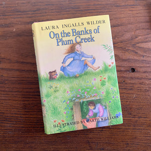 On the Banks of Plum Creek by Laura Ingalls Wilder - a 1981 HarperCollins Publisher Edition with Dust Jacket